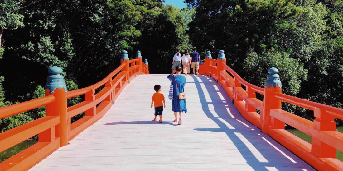 Mother and child on red bridge in Japan