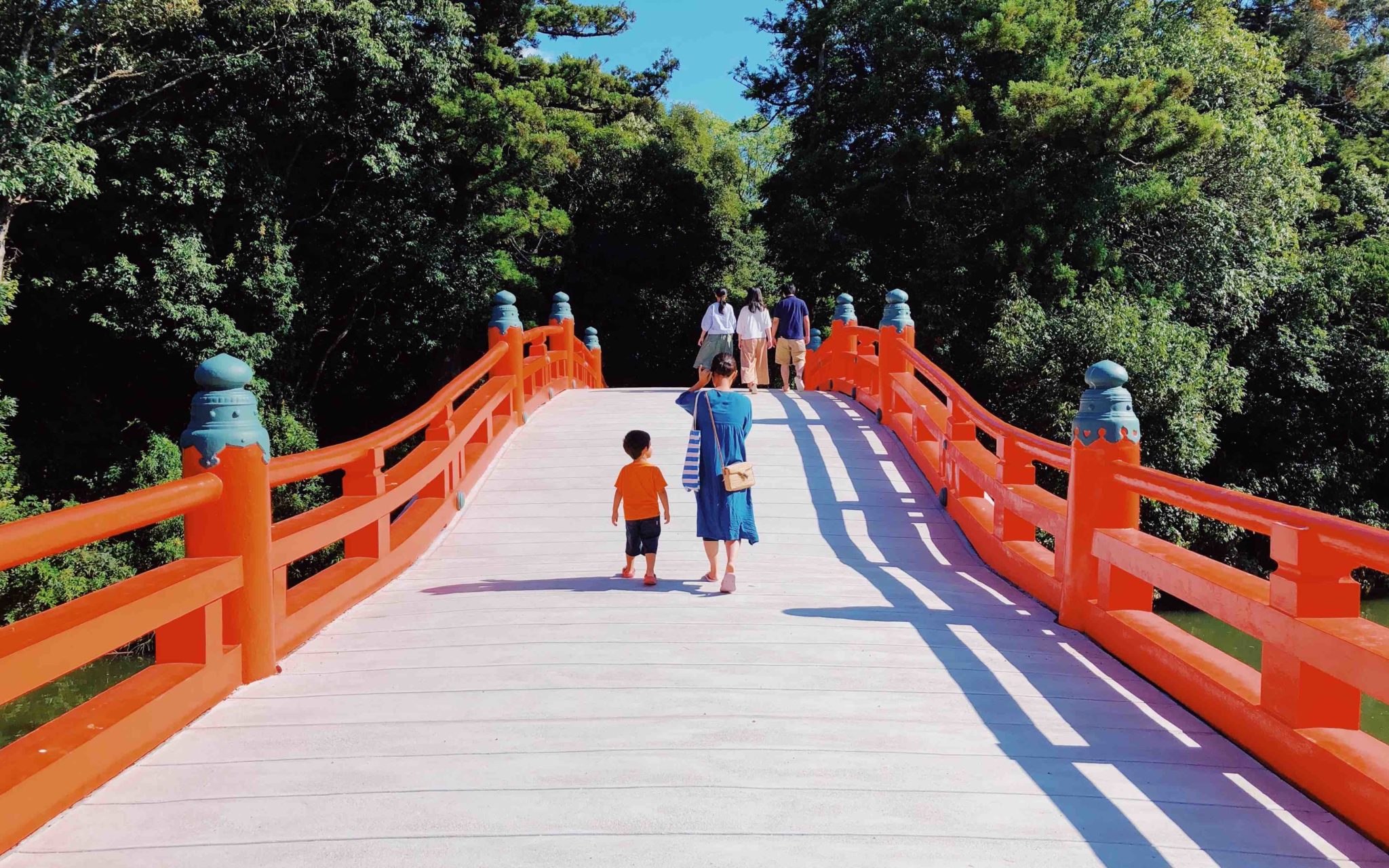 Mother and child on red bridge in Japan